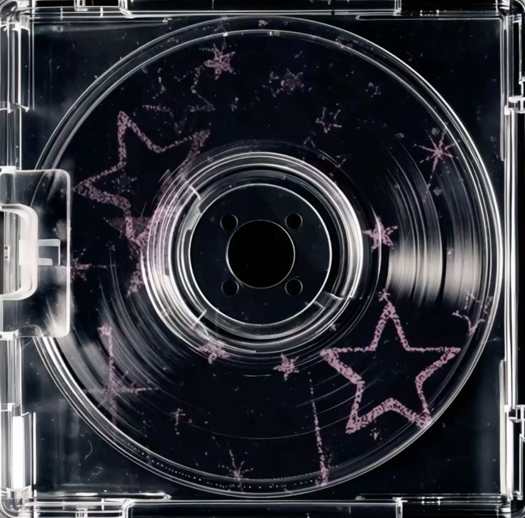 image of a cd box. The disc inside is black and has pink stars on it.